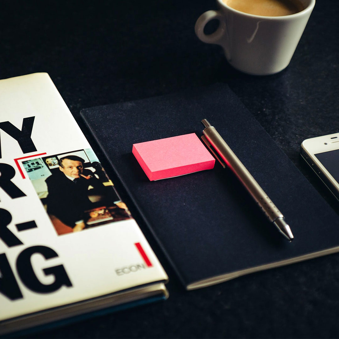 Desk with coffee, notebook, and phone